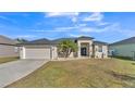 Tan house with a garage and palm trees at 5181 Ashwood Dr, Lakeland, FL 33811