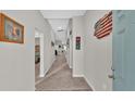 Bright and spacious entry hall with neutral-toned walls and carpet at 5440 Siltstone St, Lakeland, FL 33811