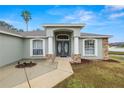 House entrance with double doors, stone accents, and a covered porch at 5819 Driftwood Dr, Winter Haven, FL 33884