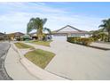 House with gray exterior, two-car garage, and landscaped front yard at 5876 Great Salt Ct, Lakeland, FL 33805