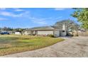 Side view of house showcasing a large yard and driveway at 6357 Neamathla Dr, Lakeland, FL 33813