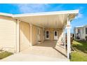 Covered carport with light-colored stone patio at 6823 S Lake Henry Ne Dr, Winter Haven, FL 33881