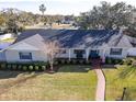 Single story home with gray roof and brick facade at 825 E Mann Rd, Bartow, FL 33830