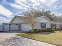 Detached garage with driveway and manicured landscaping at 825 E Mann Rd, Bartow, FL 33830