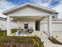 Inviting front porch with seating and manicured landscaping creates a welcoming entry to this charming home at 951 Craftsman Rd, Eagle Lake, FL 33839