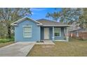 Newly built home with light blue exterior, driveway, and landscaped lawn at 1033 Fleming Ave, Lakeland, FL 33815