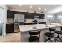 Modern kitchen with dark cabinetry, granite countertops, and stainless steel appliances at 1048 Mountain Flower, Davenport, FL 33837