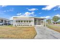 Gray manufactured home with driveway and landscaping at 1610 Reynolds Rd # 236, Lakeland, FL 33801