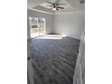 Bright bedroom featuring a tray ceiling, wood-look floors, and a glass slider at 2013 Alderman Rd, Auburndale, FL 33823