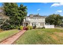 Two story house with a brick walkway leading to the front porch at 2016 Seminole Trl, Lakeland, FL 33803