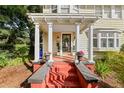 Front porch with columns, red brick steps, and potted plants at 2016 Seminole Trl, Lakeland, FL 33803
