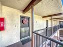 Hallway featuring secured doors and a fire extinguisher at 2025 Sylvester Rd # N304, Lakeland, FL 33803