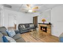 Living room with fireplace, hardwood floors and ceiling fan at 2522 Burns St, Lakeland, FL 33801