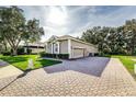 Exterior view shows a house with a paved driveway and a manicured lawn at 3116 Hawks Ridge Dr, Lakeland, FL 33810