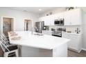 Modern kitchen with white cabinets, large island, and stainless steel appliances at 3130 Laurel Oak Ln, Winter Haven, FL 33884