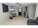 Living room with sectional sofa, large TV, and tile flooring at 345 Piedmont Ct, Bartow, FL 33830