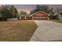 House exterior featuring a two-car garage and a driveway at 3457 Christina Groves Ln, Lakeland, FL 33813