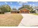 Two-car garage and a long driveway leading to the house at 3457 Christina Groves Ln, Lakeland, FL 33813