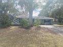 House exterior with a tree in front and a lawn at 3638 W Wheeler Rd, Lakeland, FL 33810