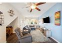 Bright living room featuring hardwood floors and a cozy sectional sofa at 4235 Winding Vine Dr # 148, Lakeland, FL 33812