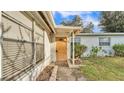 Light brown front door with a small window and walkway at 470 Lucille St, Bartow, FL 33830