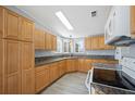 Kitchen with luxury vinyl plank flooring, light wood cabinets, and neutral countertops at 4938 Deerwood Dr, Lakeland, FL 33810