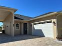 Two-story house with covered carport and paver driveway at 516 Homecoming Way, Polk City, FL 33868