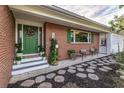 Inviting front porch with brick walkway, potted plants, and green door at 518 Boger N Blvd, Lakeland, FL 33803