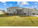 One-story house with gray siding, two-car garage, and lush green lawn at 6046 Eagle Pointe Dr, Lakeland, FL 33812