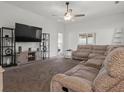 Spacious living room with large sectional sofa, TV, and ceiling fan at 6046 Eagle Pointe Dr, Lakeland, FL 33812