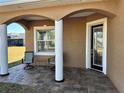 Covered porch with two chairs and a small table at 708 Teaberry Trl, Polk City, FL 33868