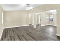 Spacious living area with gray vinyl plank floors and neutral walls at 813 Heron Pl, Winter Haven, FL 33884