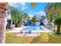 Inviting swimming pool with a tranquil fountain and lush landscaping at 813 Heron Pl, Winter Haven, FL 33884