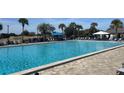 Community pool with plenty of lounge chairs and umbrellas at 8655 Sw 98Th Street Rd # A, Ocala, FL 34481