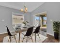 Bright dining room with modern table, chandelier, and sliding glass doors to the outdoor area at 1065 Silas St, Haines City, FL 33844