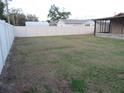 Large grassy backyard with a white privacy fence at 1125 S Woodlawn Ave, Bartow, FL 33830