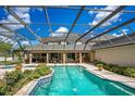Large, screened pool and patio area with fountains and lush landscaping at 1419 Hollingsworth Oaks Dr, Lakeland, FL 33803