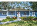 Updated mid-century ranch home with light blue paint and landscaping at 1632 Tangerine St, Lakeland, FL 33803