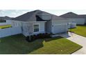 Single-story house with a gray exterior, two-car garage, and a neat lawn at 252 Walkers Point Dr, Auburndale, FL 33823