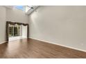 Living room with vaulted ceiling, hardwood floors and sliding doors to patio at 3133 Stonewater Dr # 3133, Lakeland, FL 33803