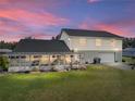Back of house with screened porch and attached garage at 4128 Mather W Rd, Lakeland, FL 33810