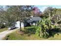 House with a spacious yard and palm trees. Located in a quiet neighborhood at 4419 Burlington Dr, Winter Haven, FL 33880
