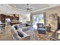 Spacious living room with sectional sofa, large windows, and open kitchen view at 4434 Micanope Crescent Dr, Lakeland, FL 33811