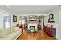 Cozy living room featuring hardwood floors, a decorative fireplace, and stylish decor at 531 Hunter St, Lakeland, FL 33803