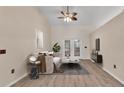 Modern living room featuring sleek furniture, a ceiling fan, and bright french doors at 6244 Napa Dr, Lakeland, FL 33813
