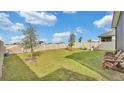 Fenced backyard with grassy lawn and a playground at 637 Griffon Ave, Lake Alfred, FL 33850