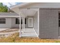 Covered porch with white columns and a light gray brick exterior at 815 N Hendry Ave, Fort Meade, FL 33841