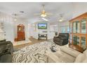 Bright living room with hardwood floors, comfortable seating, and a large TV at 1007 Canary S Cir, Lakeland, FL 33809