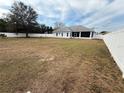 Expansive backyard featuring a white fence and ample space for outdoor activities and entertaining at 103 Paleo Point Ct, Winter Haven, FL 33880