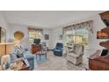 Living room with tiled floors, comfy seating, and large windows at 1600 W Lake Parker Dr # B9, Lakeland, FL 33805